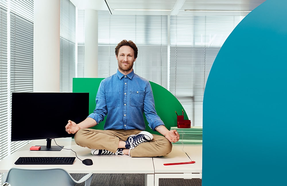 IT employee in yoga position after working smarter